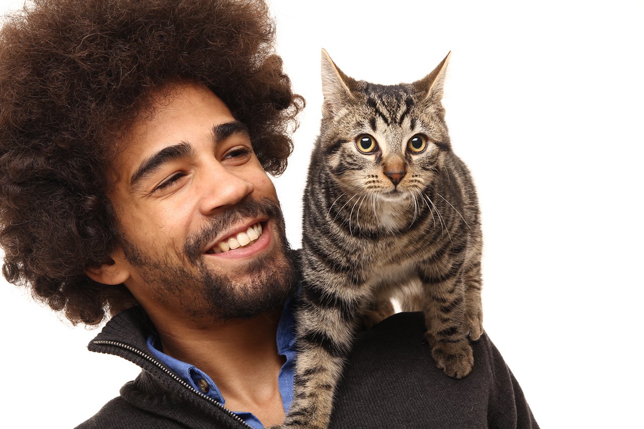 Young man and his cat smiling